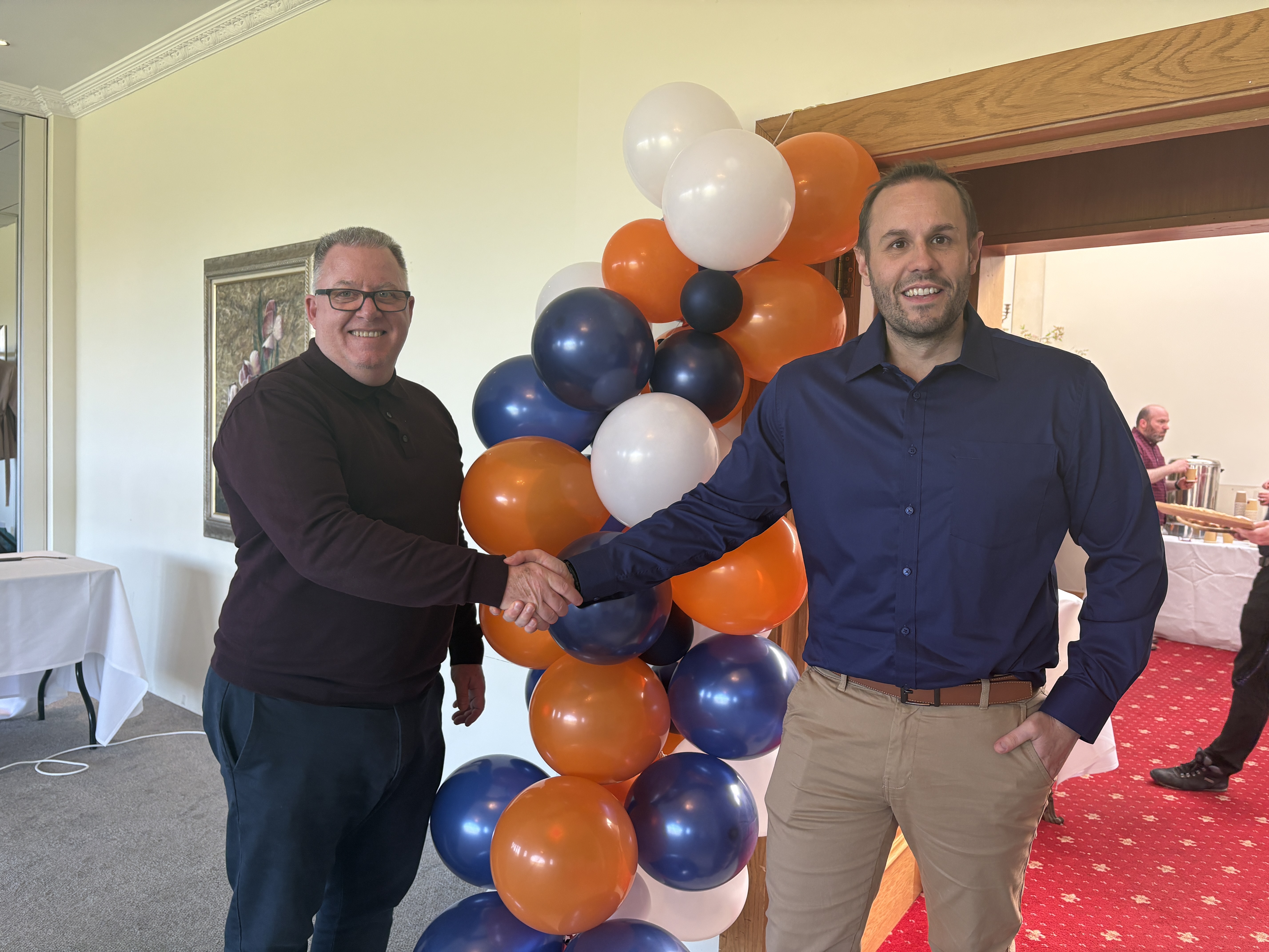 Steven Frost and Ian Barrow shaking hands for the ISO42001 news