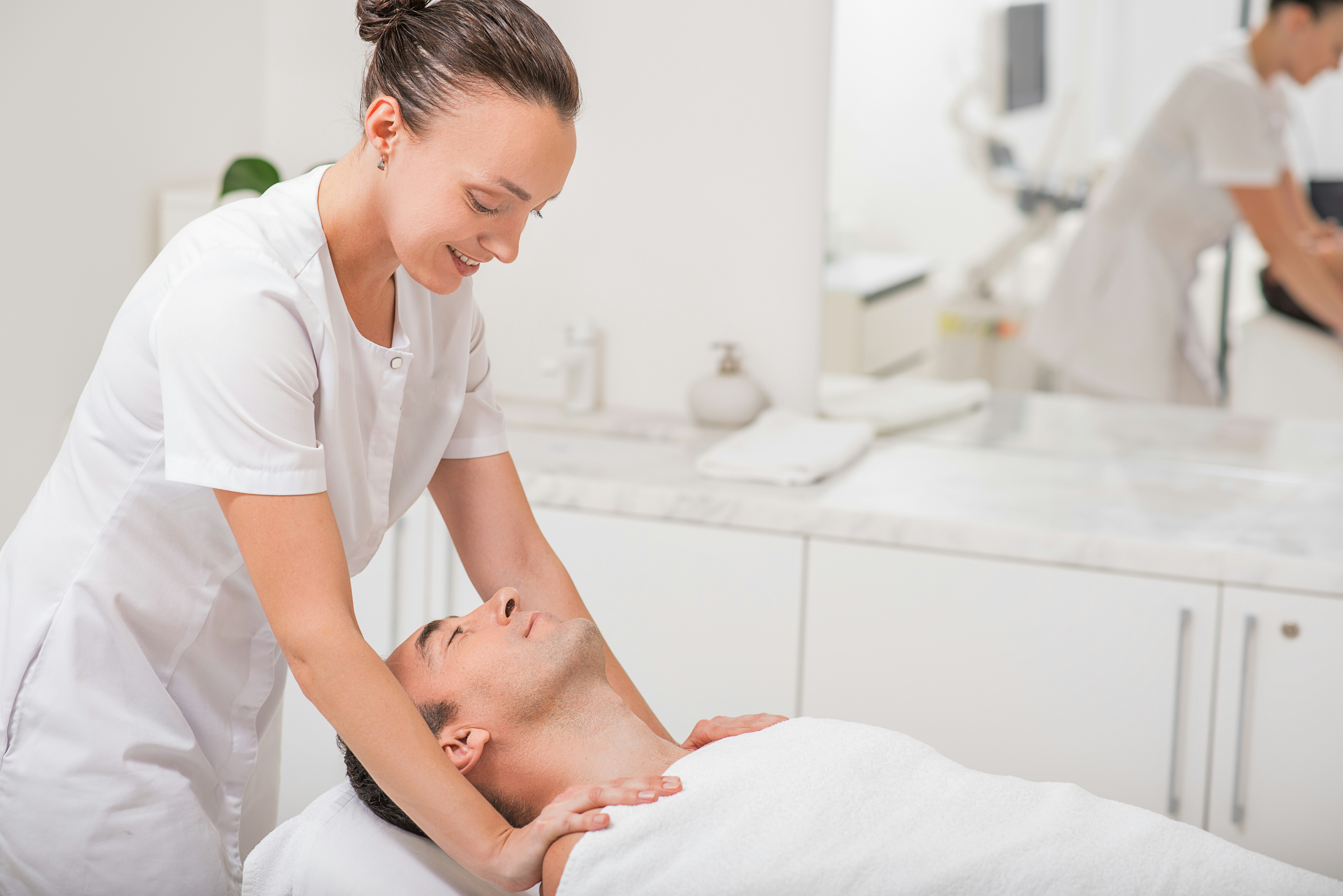 Massage therapist giving a massage to a client
